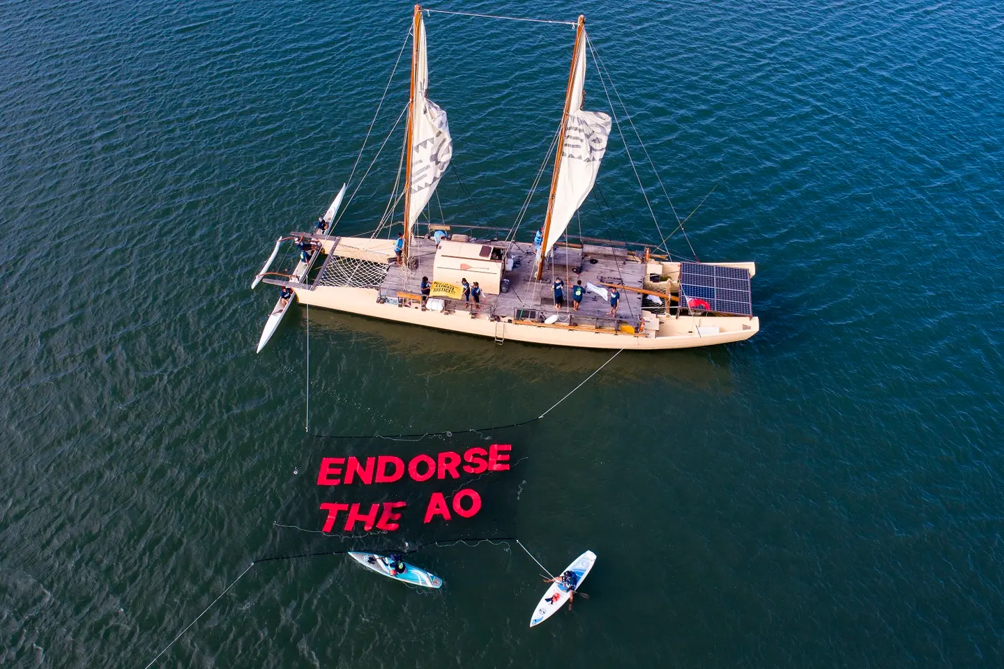 The action saw boats, canoes, and SUPs traverse the Fijian coastline, unfurling an over-water banner, with a chain of participants onshore and in the water joining with banners and chants calling on leaders to support the ICJ Advisory Opinion (AO).