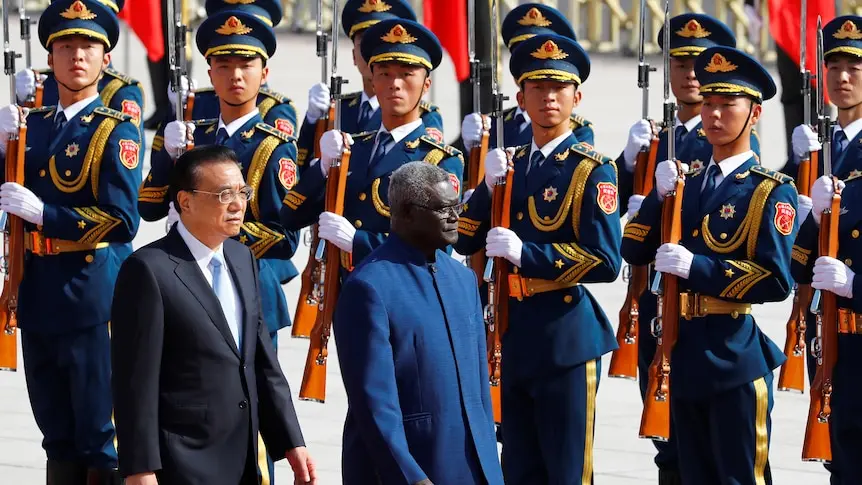Chinese Premier Li Keqiang, left, and Solomon Islands Prime Minister Manasseh Sogavare review an honor guard in Beijing.