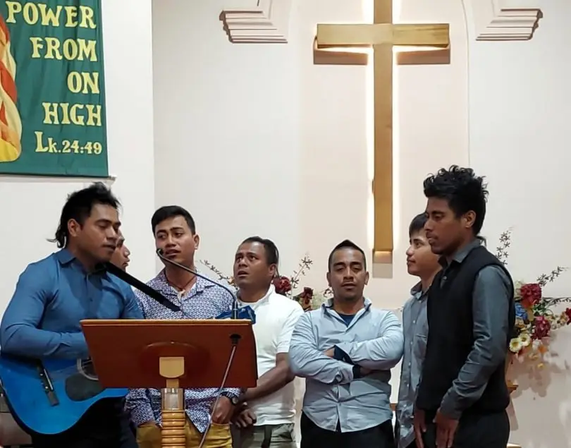 Seasonal workers stranded in Australia at a Church service.