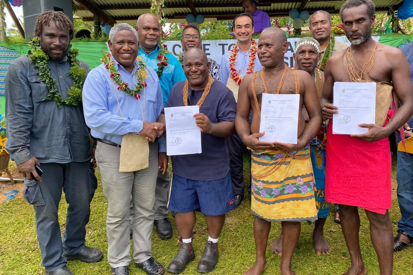 Honorable Minister for Lands, Housing and Survey (MLHS), Ishmael Avui, congratulates three landholding groups, including the Rarirahuta, Paehusi and Huniharu of East Are’ Are, for receiving their certificates of completion of the Customary Land Recording process under the Customary Land Recording Act.