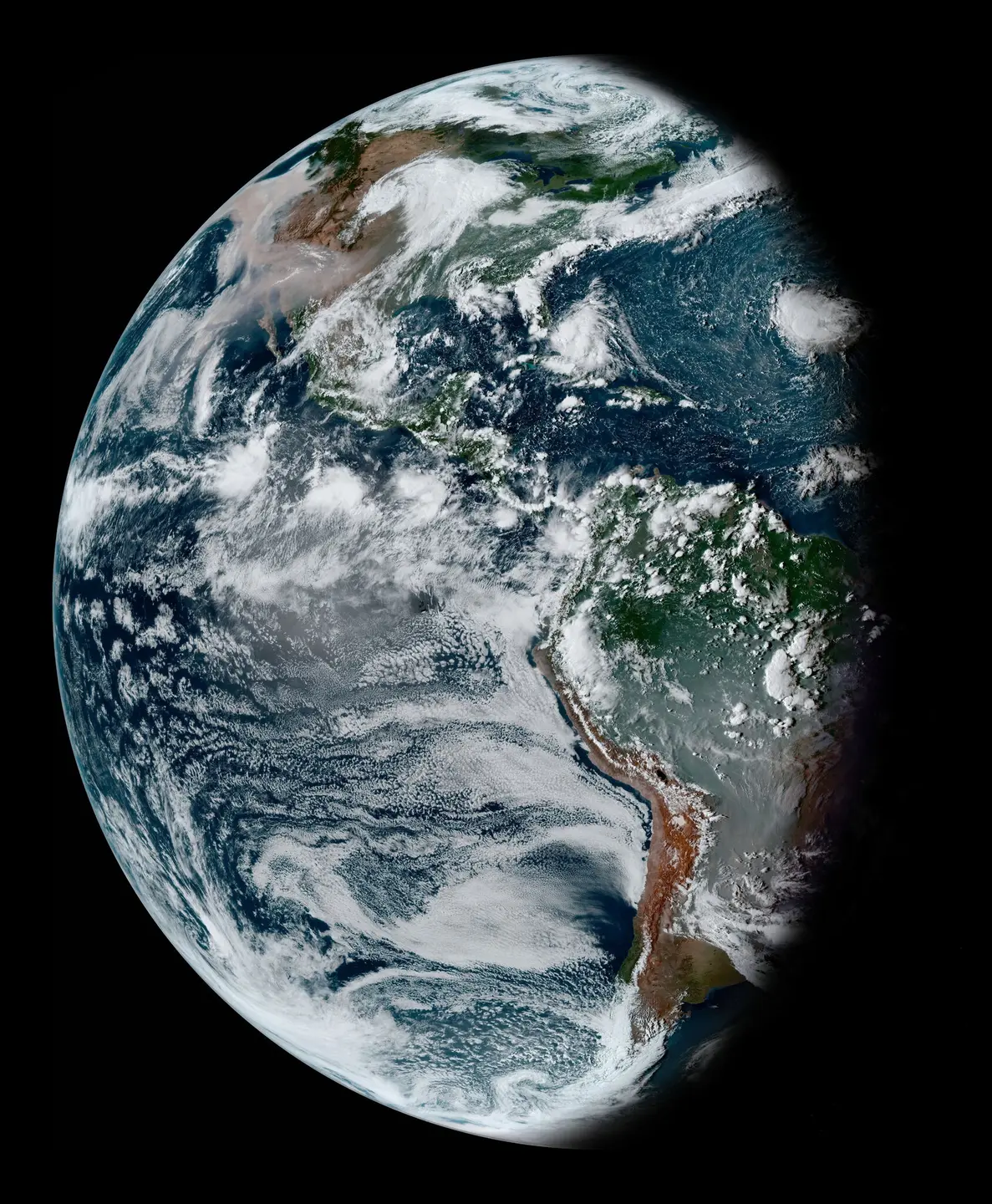 Waning gibbous Earth taken by the GOES-16 satellite on Sept. 11, 2020. Smoke from fires in the Amazon and Pantanal of Brazil dominates South America. A vast vector of smoke expands across North America and the Pacific from West Coast wildfires.