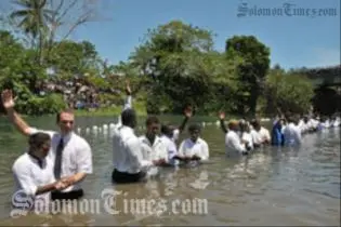 Adventist pastors baptizing new church members in the Lunga River last week.