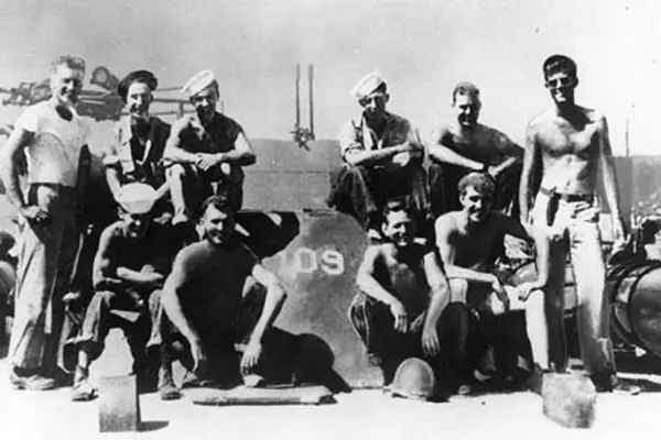 JFK and the PT-109. Lt. (jg) John F. Kennedy, USNR (standing at right) with crew of PT-109, Solomon Islands, 1943.