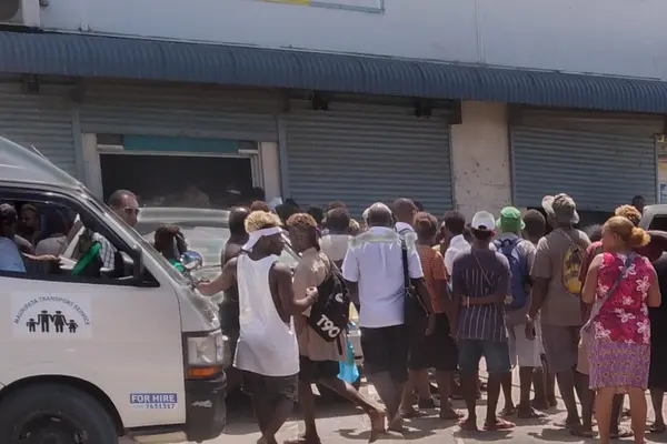 Crowd gathers outside the scene of the crime. 