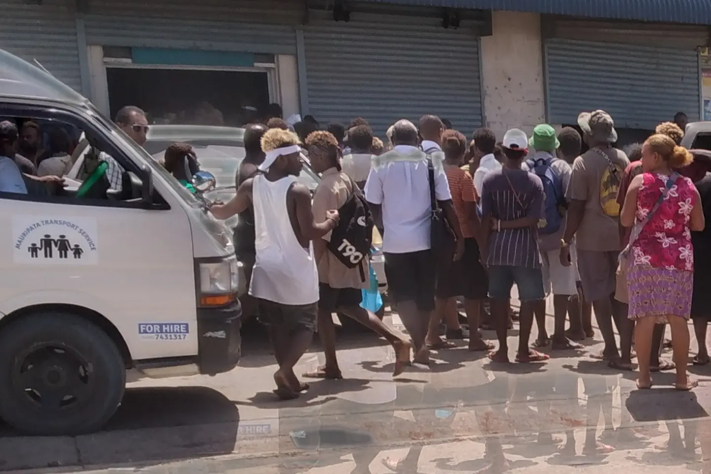 Crowd gathers outside the scene of the crime.