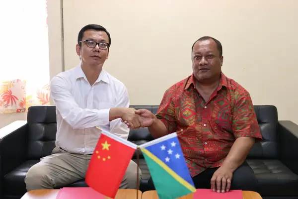Yao Ming Deputy Head of People&#39;s Republic of China Embassy in SI shaking hands with Heatlh Minister Dickson Mua following the signing of the hand over certificate.