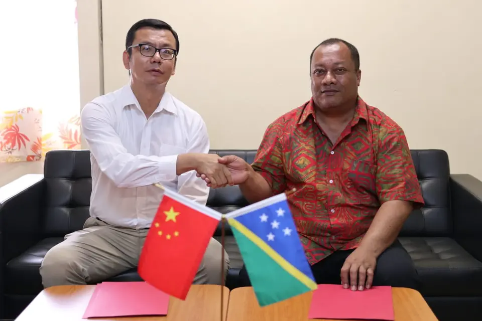 Yao Ming Deputy Head of People's Republic of China Embassy in SI shaking hands with Heatlh Minister Dickson Mua following the signing of the hand over certificate.