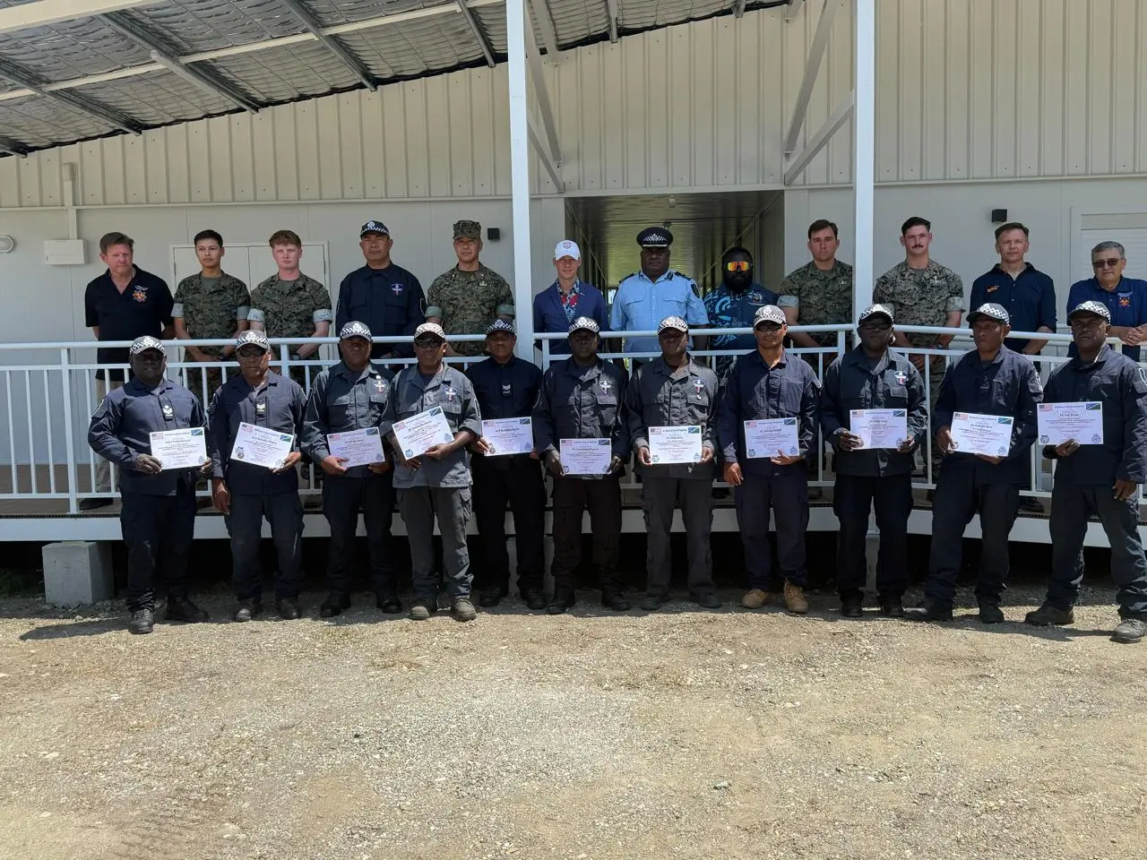 Royal Solomon Islands Police Force officers with certificates alongside U.S. Marines and officials at the new EOD facility at Hell's Point.