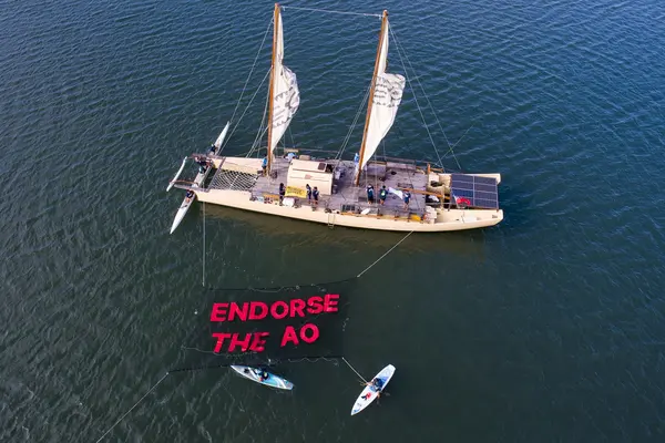 The action saw boats, canoes, and SUPs traverse the Fijian coastline, unfurling an over-water banner, with a chain of participants onshore and in the water joining with banners and chants calling on leaders to support the ICJ Advisory Opinion (AO).