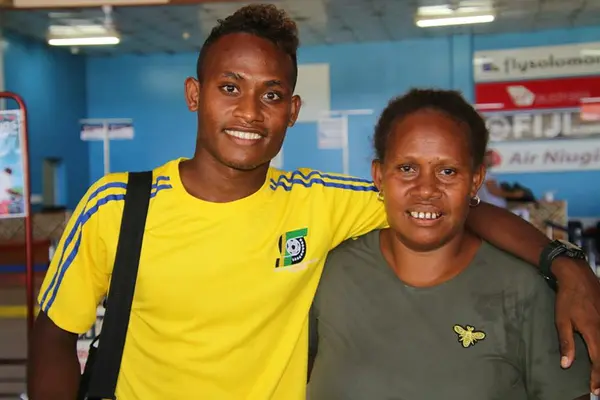 Youngster, Raphael Ohanua Leai with his proud mother at the Honiara International Airport.