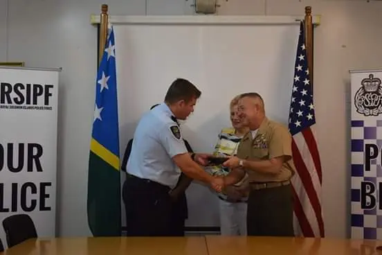 Commissioner Varley receives a gift from a member of the US delegation.