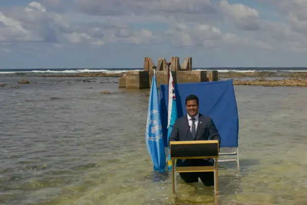 Hon. Minister Simon Kofe filming a video statement in Tuvalu on climate mobility.