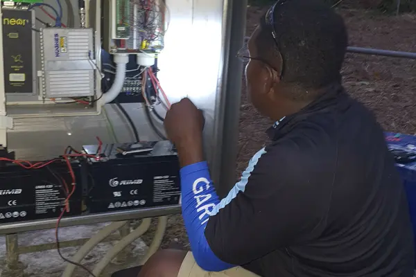 MET Service Chief Technical  Officer, Mr. Barnabas Tahunipue at work on the Automatic Weather Station in Tikopia