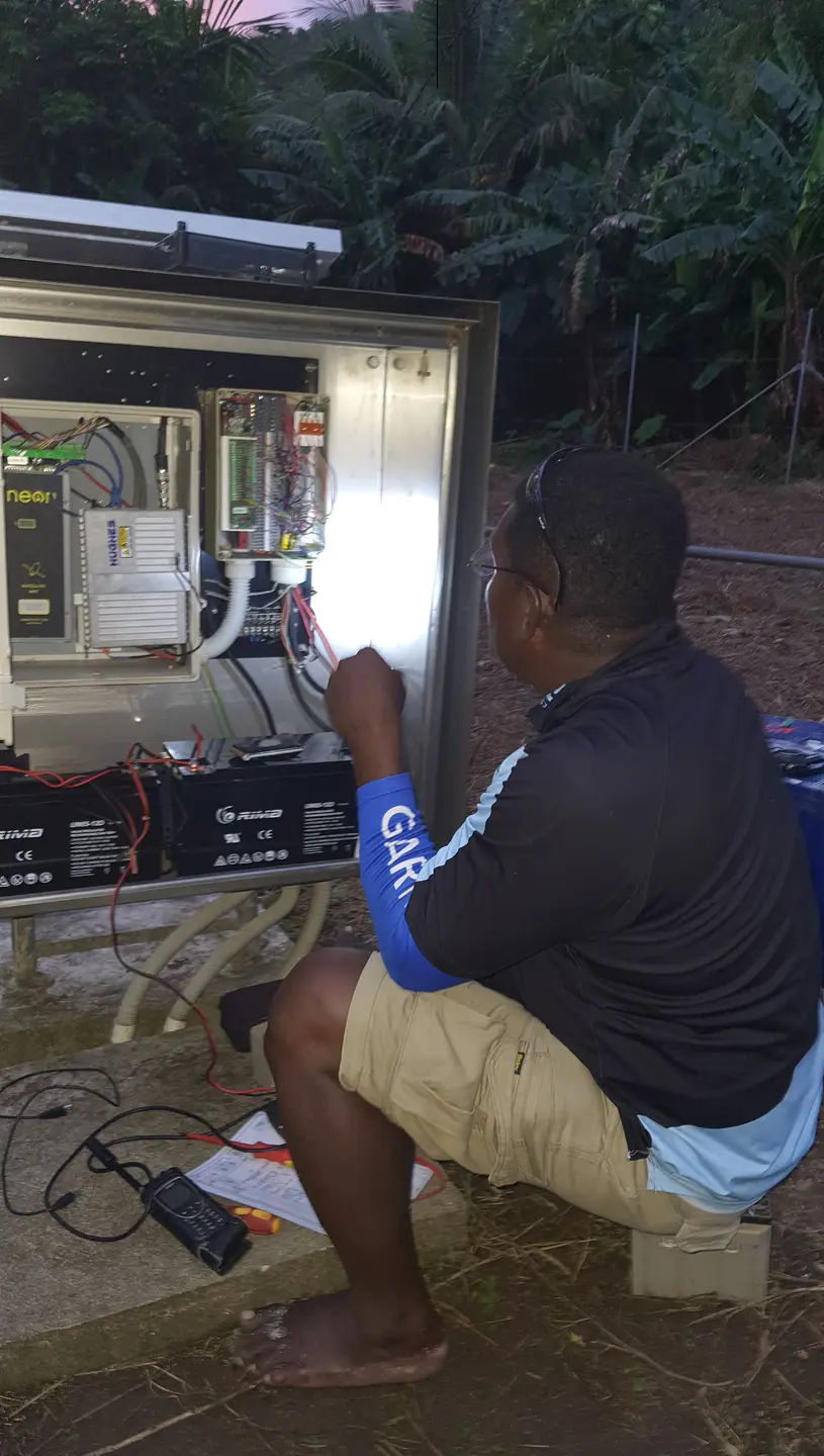 MET Service Chief Technical  Officer, Mr. Barnabas Tahunipue at work on the Automatic Weather Station in Tikopia
