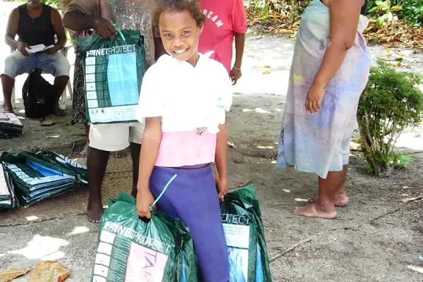 Members of the community receiving bed nets in Titiana Village.