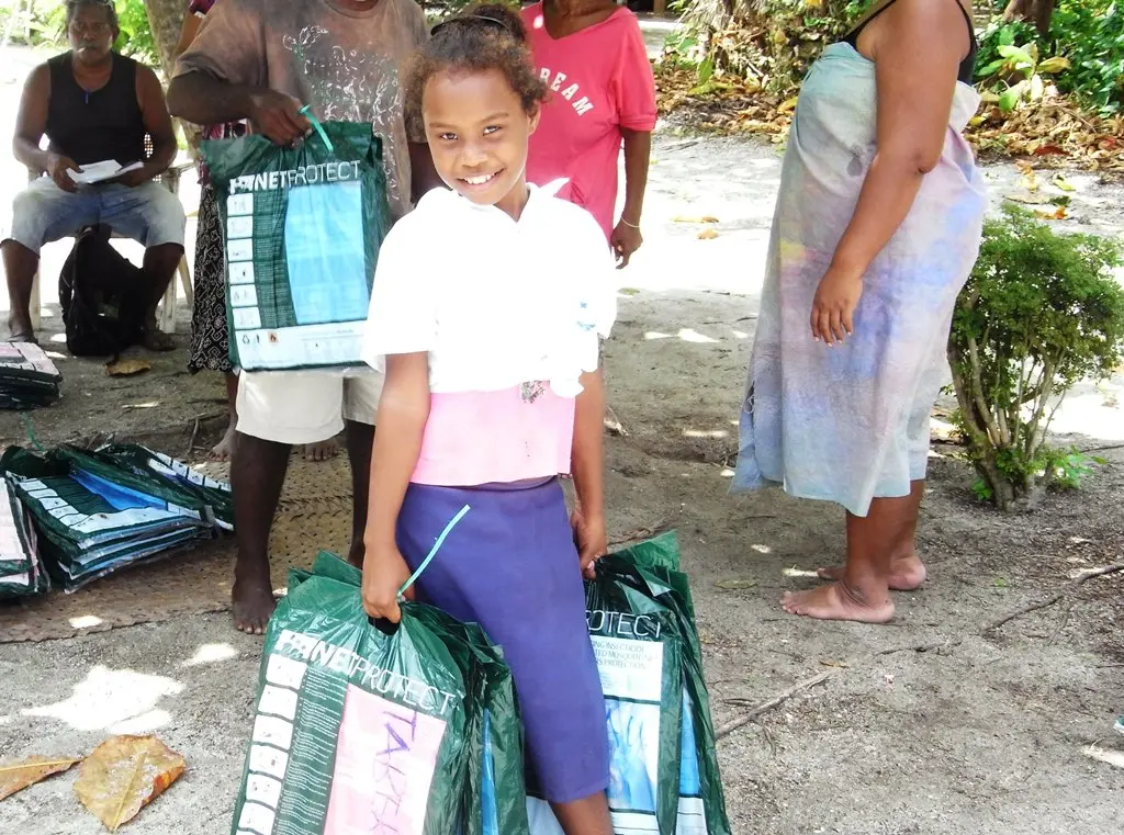 Members of the community receiving bed nets in Titiana Village.
