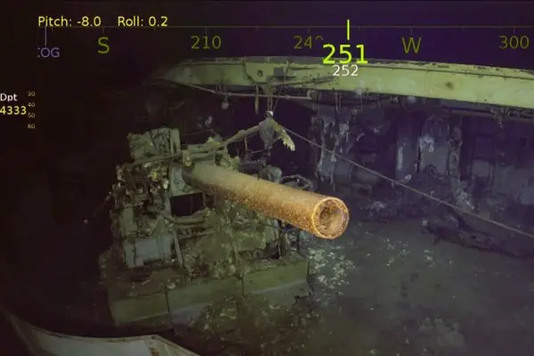 One of the USS Wasp’s five-inch guns looms out of the murk of the Coral Sea.  