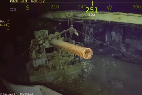 One of the USS Wasp’s five-inch guns looms out of the murk of the Coral Sea.