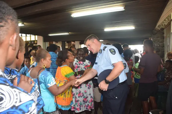 Commissioner Varley shakes hands with some women after the awareness program.
