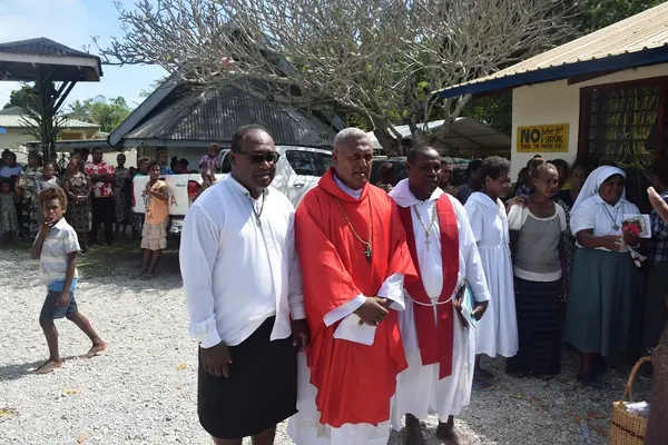Fr Maelanga (center) and his brother Hon Manasseh Maelanga and a relative priest.