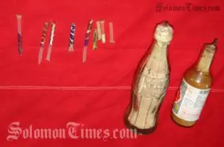 Two improvised explosives made from bottles, explosive powder and  wick fuses seized by police.