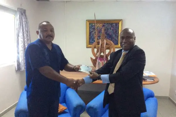 Ambassador Moses K. Mose (right) handed over Euro 20,000 on behalf of the ACP Group to Acting Minister for Foreign Affairs Hon. Georges Wells (left)