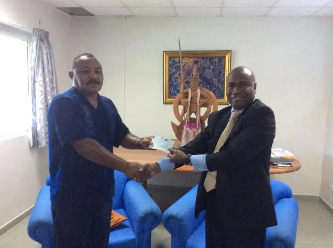 Ambassador Moses K. Mose (right) handed over Euro 20,000 on behalf of the ACP Group to Acting Minister for Foreign Affairs Hon. Georges Wells (left)