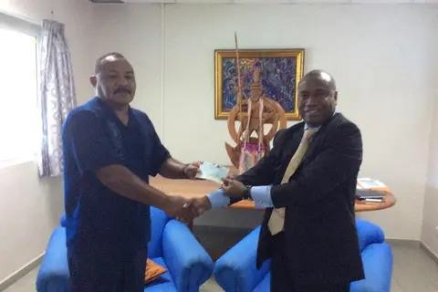 Ambassador Moses K. Mose (right) handed over Euro 20,000 on behalf of the ACP Group to Acting Minister for Foreign Affairs Hon. Georges Wells (left)