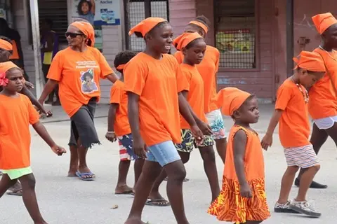 Promoting the 16 Days of Activism and walking against corruption are children, during the Anti-Corruption Day march in Gizo.