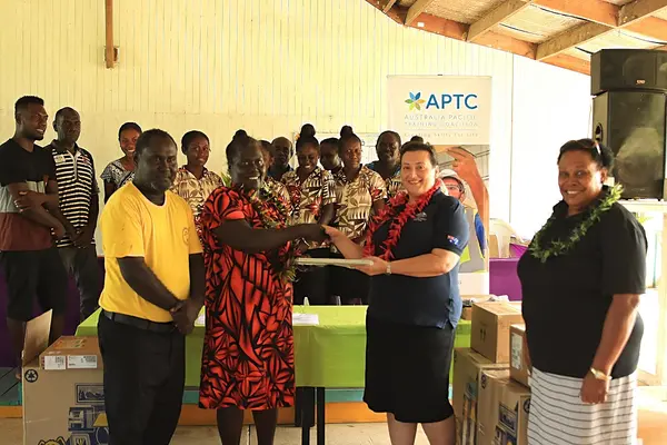 Second Secretary at the Australian High Commission in Solomon Islands, Christina Skoumbourdis, hands over laptops to Tabak reps.