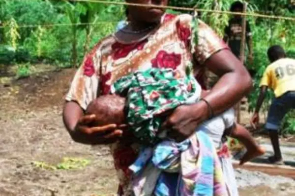 A woman with her child enjoying a necessity many take for granted, running water.