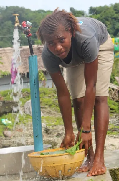 A young lady from Nea village is able to have access to clean water thanks to World Vision.