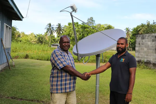 Constituency Development Officer (CDO) Collin Bemama Qalokisa shake hands with Alphie Nelson, field Engineer from Fuzionnet Company Ltd after the successful installation.