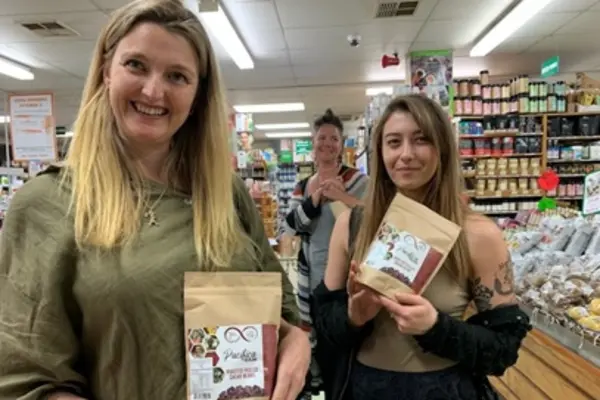Customers in New Zealand holding Solomon Islands cocoa products.