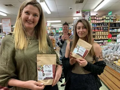 Customers in New Zealand holding Solomon Islands cocoa products.