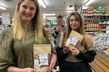 Customers in New Zealand holding Solomon Islands cocoa products.