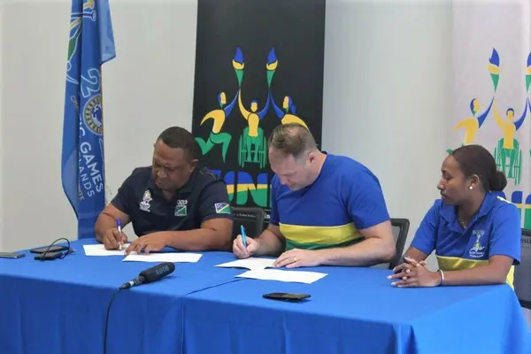 SIVF President Morris Maitaki (Far left), SINIS High - Performance Executive Director Aaron Alsop (center) signing the MOU witnessed by Portfolio 2 (Team Sports) Performance Manager Amanda Korinihona.