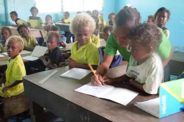 Little children of the Kilusakwalo Christian Community High School in their newly renovated classroom, thanks to their dedicated teachers and Jane Sheils, an Australian Volunteer.