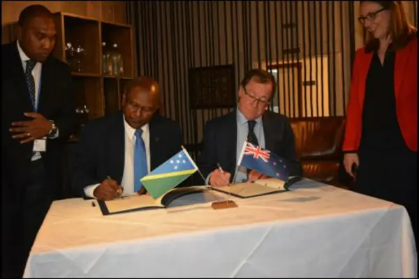Hon. Milner Tozaka, MP, Minister of Foreign and External Trade and his counter-part, Hon. Murray McCully MP, Minister of Foreign Affairs of New Zealand sign the revised Joint Commitment for Development. 