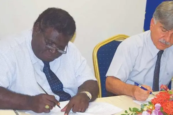 Minister for Development Planning and Aid Coordination, Hon Philip, left, and the EU Ambassador to Solomon Islands HE Tezapsidis sign the SBD$90-Million financing agreement.