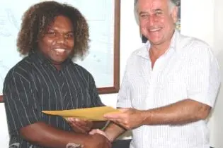 HE Mr Frank Ingruber, congratulating Mr Lamani on his selection and presenting him with travelling documents and other material for the internship.
