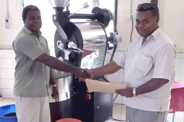 General Manager of Varivao Holdings, Dudley Longamei and IACT Team Leader, Samu Turagacati shake hands during the handover of machines as part of IACT's assistance.