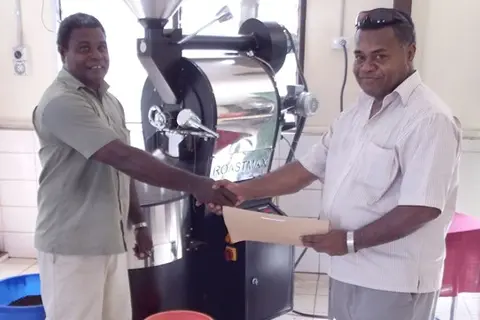 General Manager of Varivao Holdings, Dudley Longamei and IACT Team Leader, Samu Turagacati shake hands during the handover of machines as part of IACT's assistance.