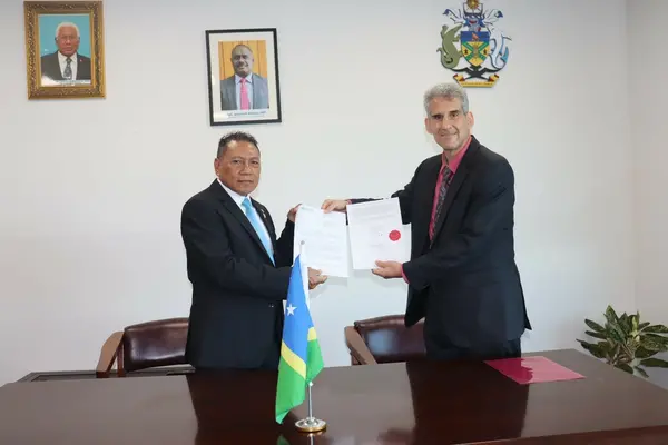 WHO Country Representative to SI Dr. Howard Sobel (R) presenting his credential to MFAET Supervising Minister Hon. Peter Shannel Agovaka (L)