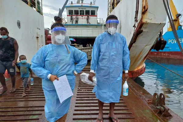 Volunteers at the wharf helping out with swabbing and COVID-19 testing using RAT kits for arriving passengers from the provinces.