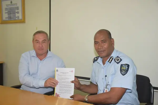 Acting Commissioner Mostyn Mangau and the Solomon Telekom Chief Executive Officer (CEO) Arthur Yen, with the signed Memorandum of understanding (MoU).