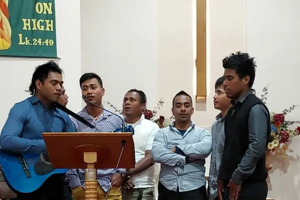 Seasonal workers stranded in Australia at a Church service.