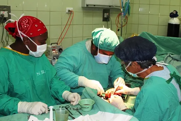 Australian surgeon Darrell Nam in surgery with local medical staff during the Interplast visit to Honiara in 2011.