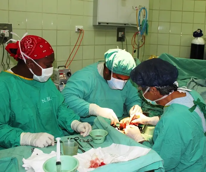 Australian surgeon Darrell Nam in surgery with local medical staff during the Interplast visit to Honiara in 2011.
