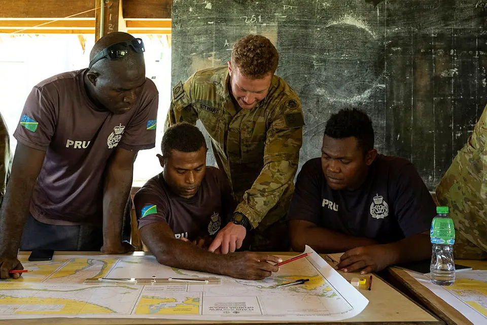 Private Brandon Stewart from 2nd Battalion, Royal Australian Regiment, teaches navigation theory to Royal Solomon Islands Police Force members.